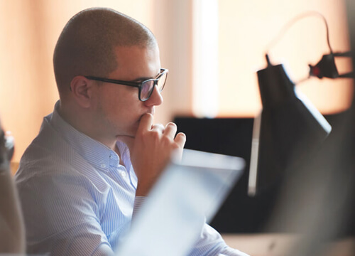 Software developer working on computer at modern office